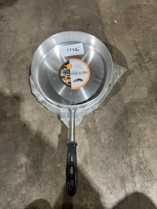 Brand new Vollrath Wear-Ever 12" aluminum sauté pan, model 67735, with black riveted grip handle, tags visible.