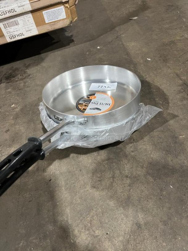 Brand new Vollrath Wear-Ever 12" aluminum sauté pan, model 67735, with black riveted grip handle, tags attached.