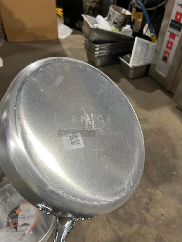 Brand new Vollrath Wear-Ever 12" aluminum sauté pan, model 67735, with black riveted grip handle, visible branding.