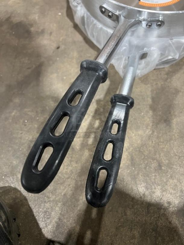 Brand new Vollrath Wear-Ever 12" aluminum sauté pan, Model 67735, with black riveted grip handle, 5 qt capacity.