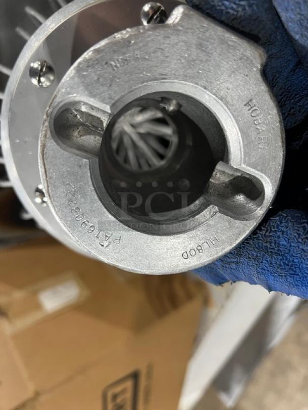 Brand new Hobart DWHIP-HL80 stainless steel 80 qt. wire whip attachment, markings visible; pristine condition.