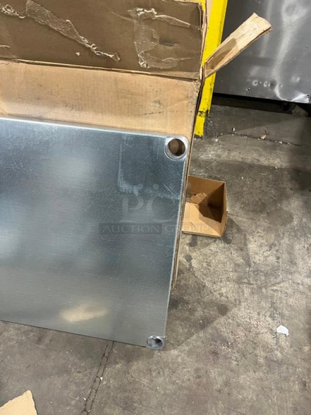 Brand new Advance Tabco UG-30-96, 18 gauge galvanized steel worktable undershelf, 30"x96", shown partially unpacked.