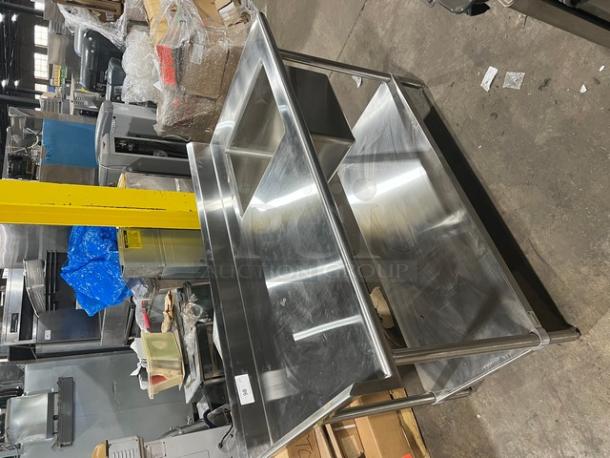 Brand new Advance Tabco stainless steel worktop/prep table with right-side sink, undershelf, back, and left-side splash, on legs.