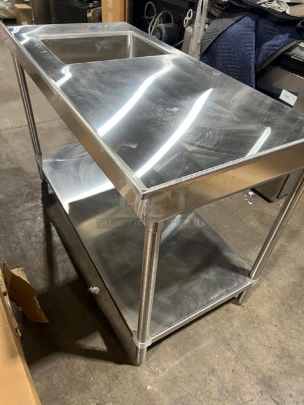 Brand new Advance Tabco stainless steel worktop with undershelf, right-side sink, back and left-side splash, on legs.