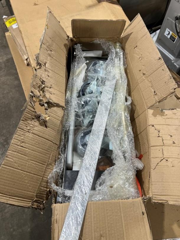 Brand new commercial double convection oven stacking kit with casters, in original packaging, partially unpacked in box.