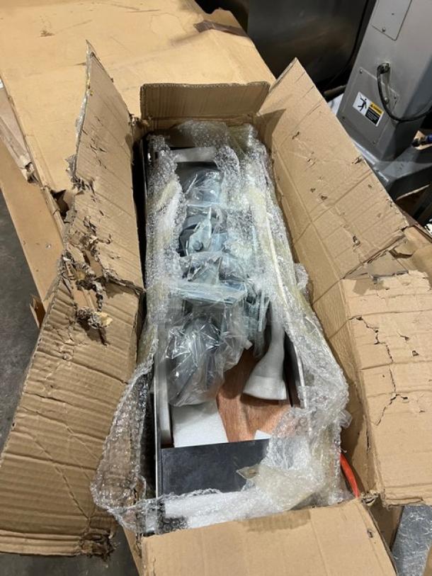 Brand new commercial double convection oven stacking kit with casters in original damaged packaging, includes wrapped components.