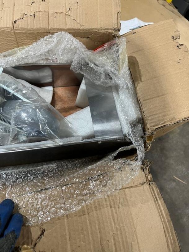 Brand new commercial double convection oven stacking kit with casters in original packaging, partially visible with bubble wrap.