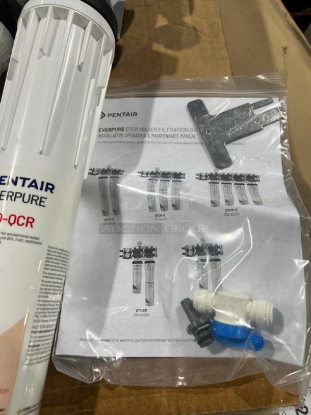 Brand new Pentair Everpure QT1+CR water filtration system with manual and installation components visible.