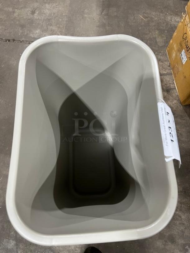 Rubbermaid commercial beige trash can, new condition, medium size. Auction tag indicates "4X Your Bid!"