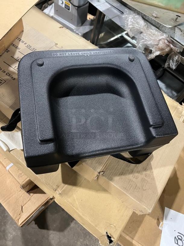 Brand new Carlisle 7114 black polypropylene dual-sided booster seat with safety strap. Durable, lightweight design.