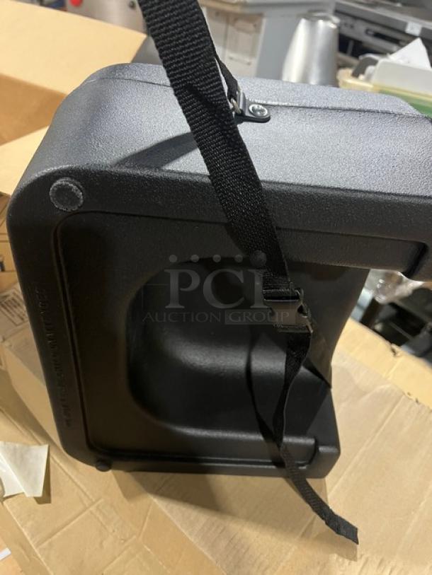 Brand new Carlisle 7114 black polypropylene dual-sided booster seat with safety strap.