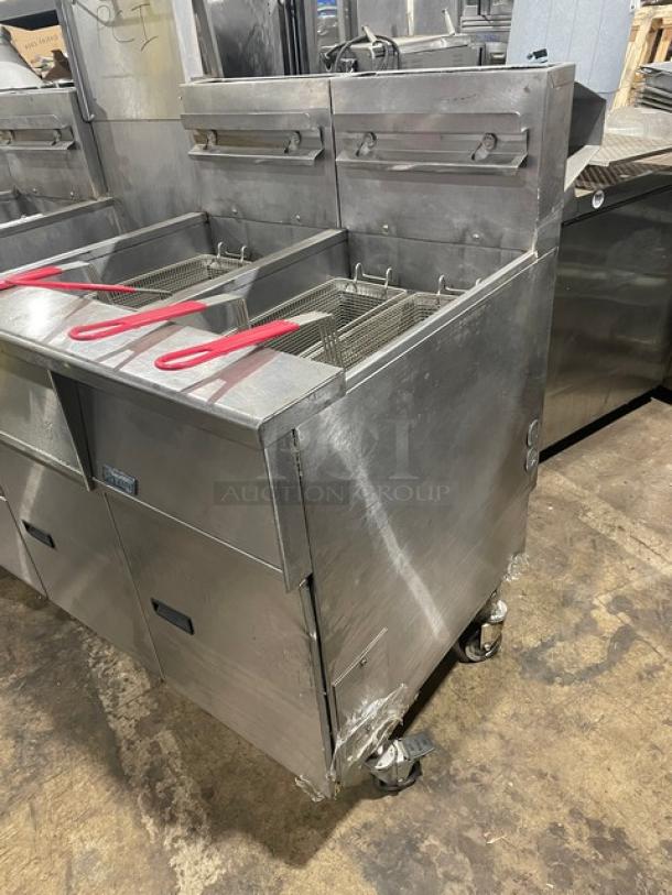 Pitco FG-SGH50 commercial stainless steel 4-bay 50 lb. deep fryer system, natural gas, with basket hanger, backsplash, on casters.