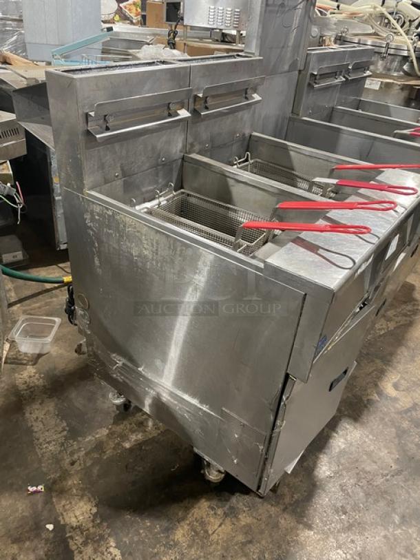 Pitco FGSGH50 commercial 4-bay deep fryer, stainless steel, natural gas powered, with basket hanger, filter, on casters.