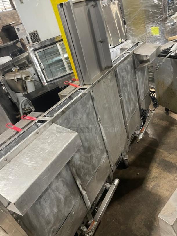 Pitco FGSGH50 commercial 4-bay stainless steel fryer system, with center basket hanger, back splash, and oil filter. Natural gas.