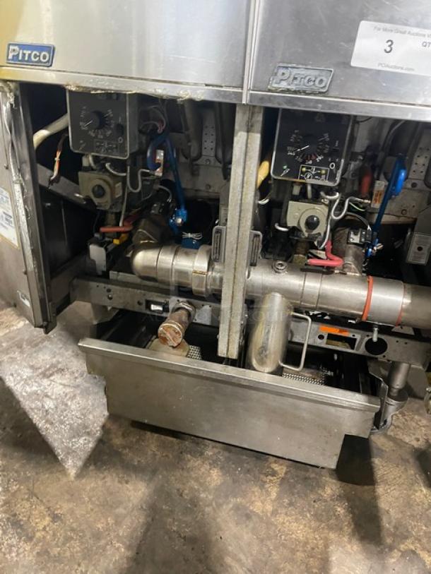 Pitco FGSGH50 commercial deep fryer, 4-bay, stainless steel, gas-powered, center basket hanger, oil filter, on casters.