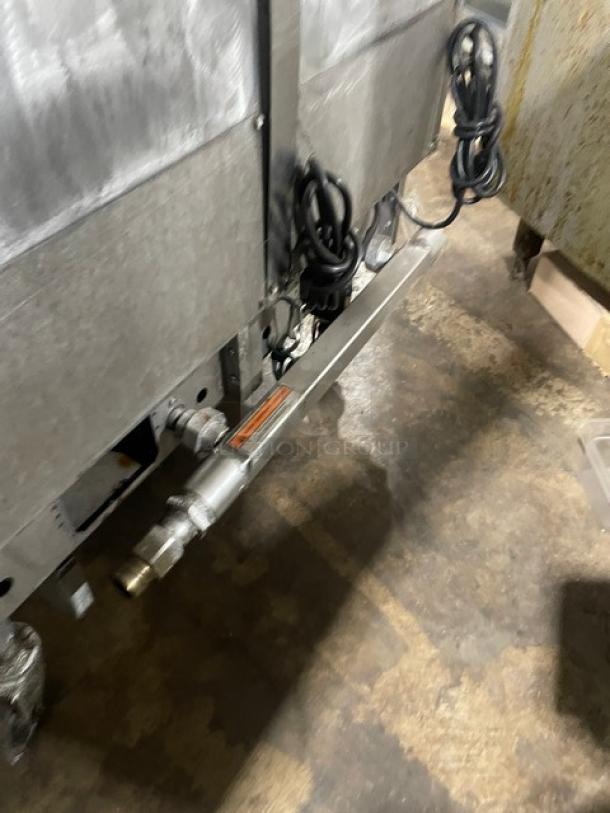 Pitco FGSGH50 stainless steel 4-bay deep fat fryer on casters, with basket hanger, backsplash, and oil filter. Natural gas powered.