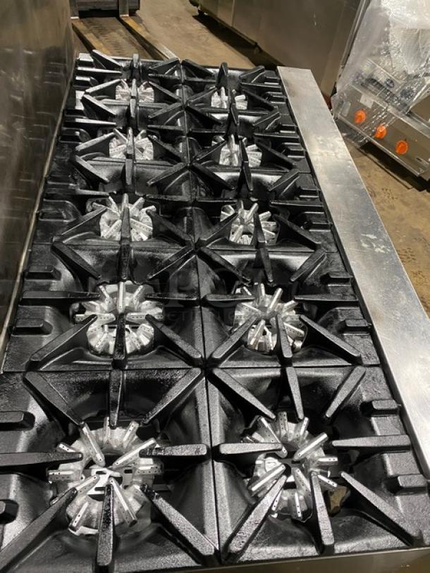 Garland stainless steel 10-burner range and double oven combo. Features backsplash, wired oven rack, and leg support.