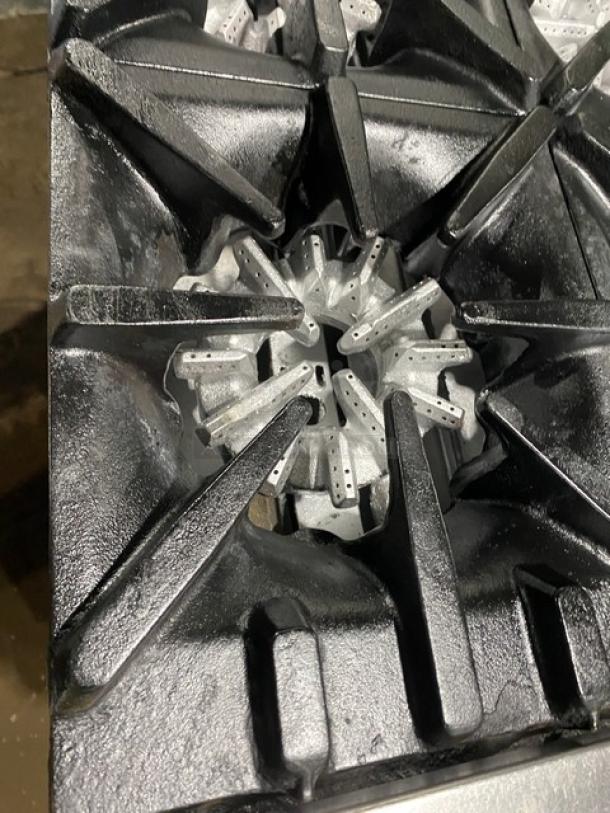 Garland stainless steel 10-burner range with double oven, backsplash, and wired rack. Natural gas, good condition.