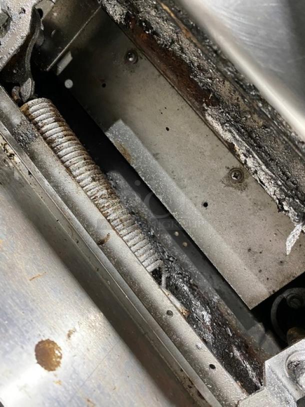 Garland commercial stainless steel natural gas 10 burner range with double oven, backsplash, and wired rack.