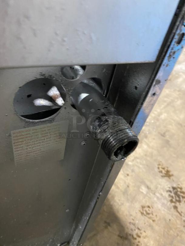 Garland commercial stainless steel natural gas 10 burner range and double oven combo with backsplash, wired oven rack, on legs.