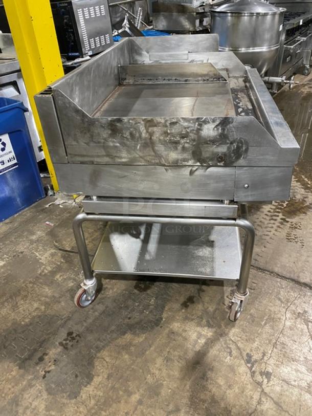 WoodStone stainless steel natural gas countertop plancha griddle with back and side splash, single undershelf cart on casters.