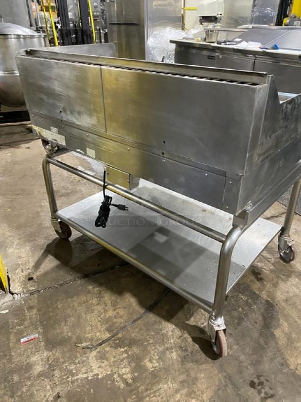 WoodStone commercial stainless steel countertop plancha griddle on equipment cart. Features back & side splash, undershelf, casters. Serial: GP1B16MAY1704992.