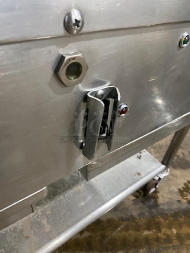 WoodStone stainless steel natural gas plancha griddle with undershelf cart. Features back and side splash, casters.