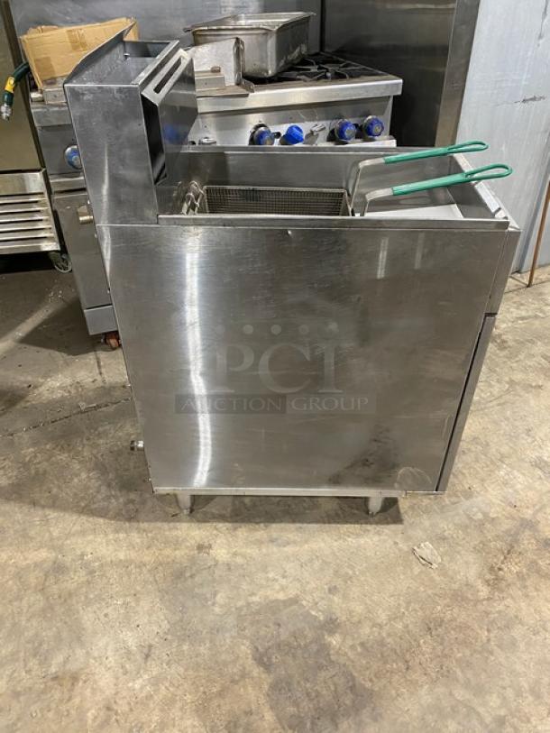 American Range commercial stainless steel deep fryer with natural gas power. Features a back splash, basket hanger, and fry basket. Mounted on legs.