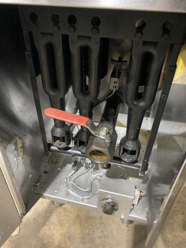 American Range commercial stainless steel natural gas deep fat fryer interior, showing gas burners and valve, with red-handled control.
