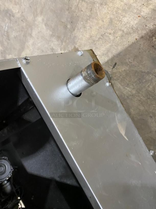 American Range commercial stainless steel natural gas fryer corner detail, with visible connector; robust condition.