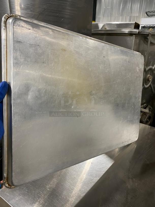 Commercial stainless steel fast food serving tray, rectangular, well-polished surface, light scratches visible, durable.