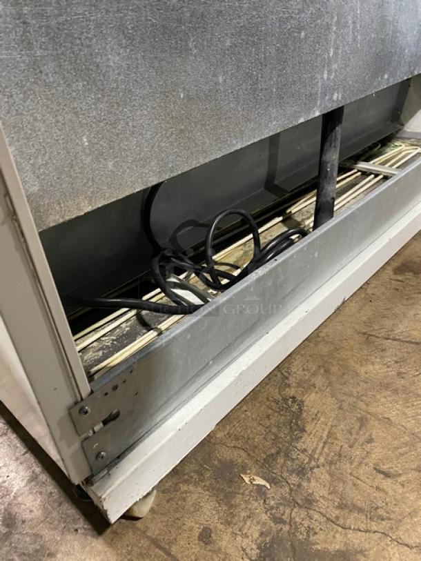 Beverage Air MB13US commercial white refrigerated 5-tier display case, open grab-n-go design, visible wear, 115V, 1 Phase.