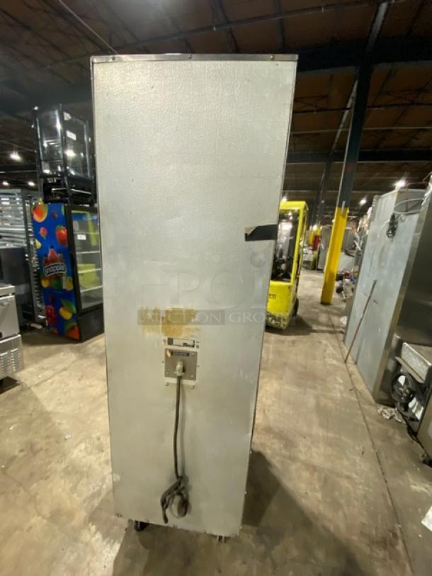 Alto-Shaam stainless steel cook and hold oven, model 1000-41P, full-height with solid half doors, built-in pan slides, on casters.