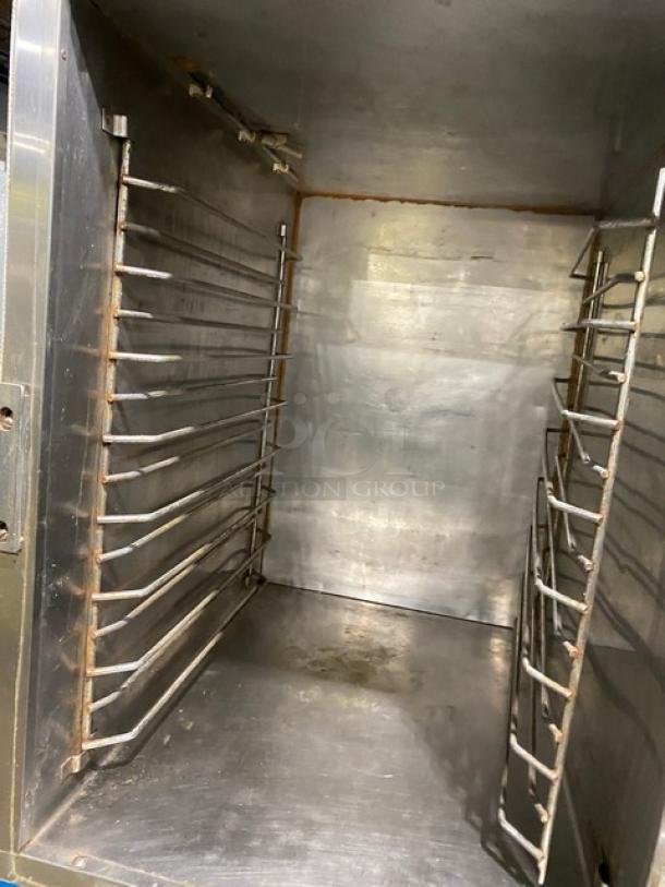 Alto-Shaam 1000-41P stainless steel full-height cook & hold oven, built-in pan slides, visible interior with racks, on casters.