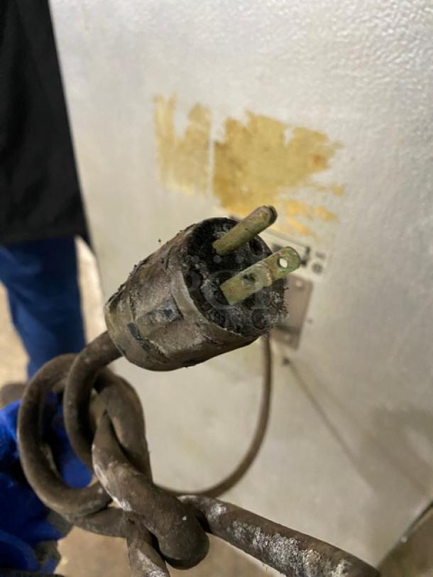 Alto-Shaam electric oven power cord showing a worn plug with visible rust and discoloration, near a scratched metal surface.