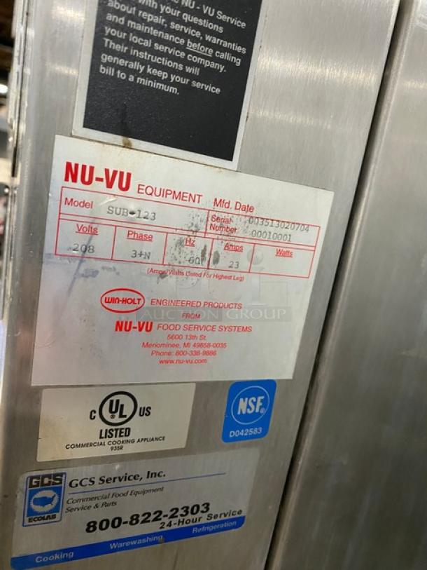 Nu-Vu SUB-123 commercial convection oven/proofer combo on casters. Features stainless steel build, oven racks, and 208V 3-phase power. Serial: 00351302070400010001. Markings show UL and NSF certifications.
