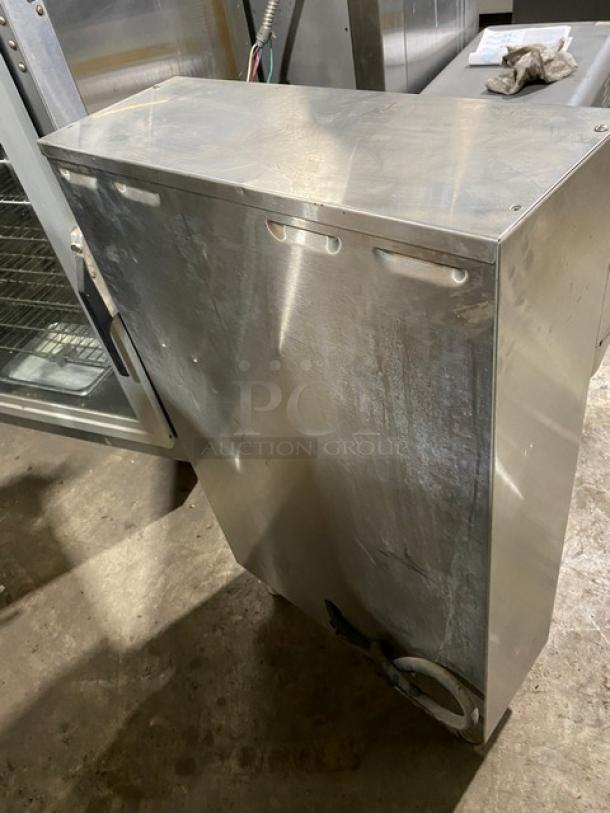 Fetco CBS-2052 commercial stainless steel countertop coffee machine, electric-powered, on legs, visible wear.