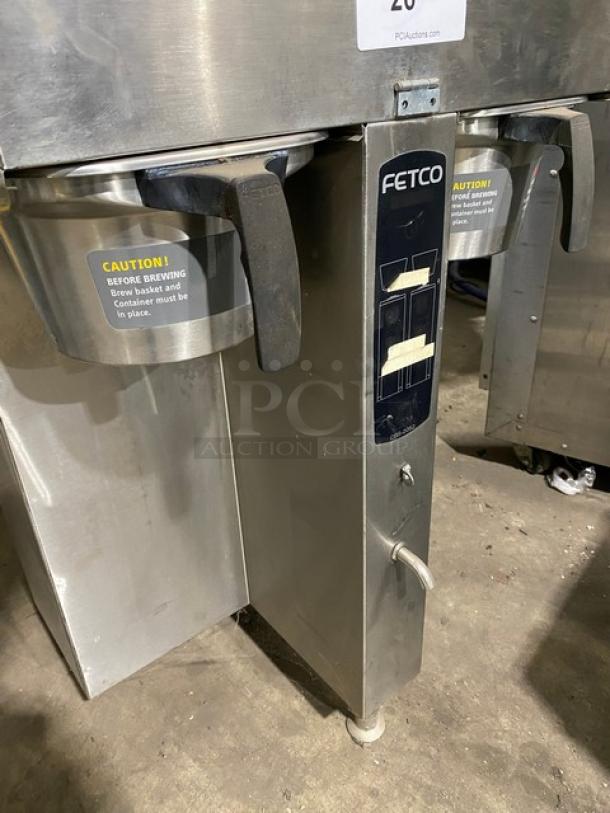 Fetco CBS-2052 commercial stainless steel coffee machine, electric, on legs, visible caution labels, in used condition.