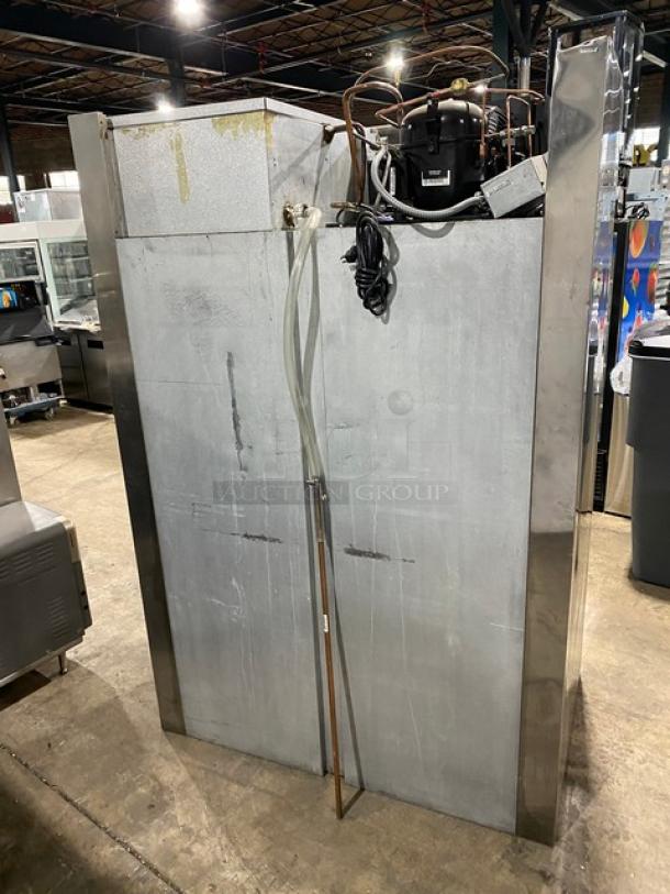 Traulsen commercial refrigerator, model RHT232NREFSL, with double sliding glass doors, wired racks, 115V, on legs.