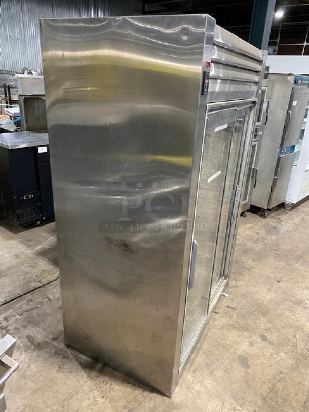Traulsen RHT232NREFSL commercial fridge with double sliding glass doors, wired racks, stainless steel, on legs, 115V, good condition.