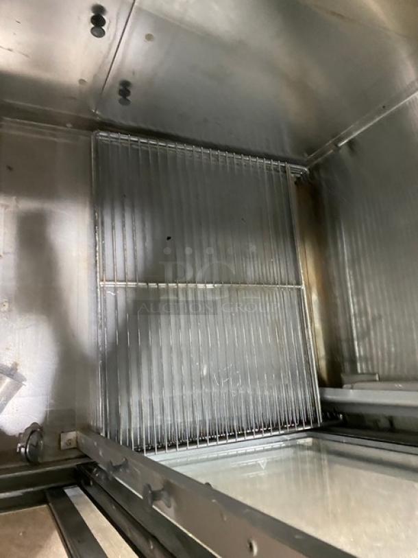 Traulsen commercial refrigerator interior with wired racks. Model RHT232NREFSL, sliding glass doors, 115V, on legs.