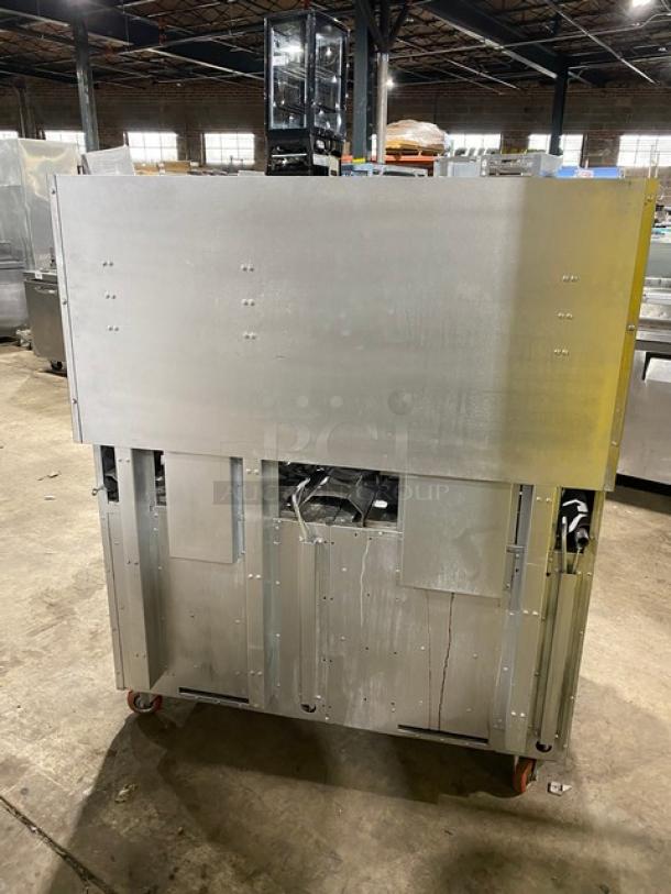 American Range stainless steel 8-burner range with double oven, backsplash, overhead salamander shelf, and casters; natural gas.