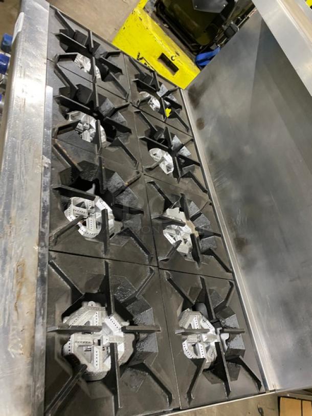 American Range 8-burner stainless steel commercial range with double oven, backsplash, salamander shelf, and casters.