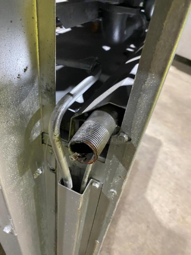 American Range commercial stainless steel natural gas-powered range view. Shows piping detail. 8-burner, double oven combo.