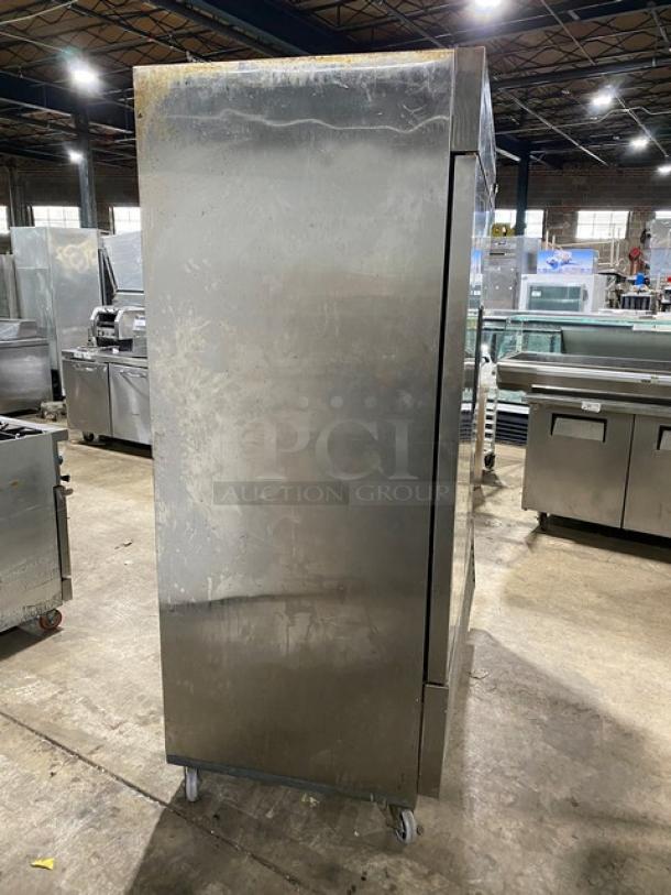 Duker's D55F commercial stainless steel solid 2-door reach-in freezer, poly-coated wire rack, 115V, on casters.