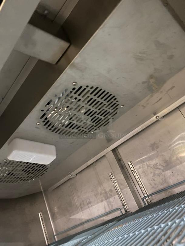 Duker's D55F commercial stainless steel reach-in freezer interior, featuring poly coated wired rack, on casters. Model: D55F.