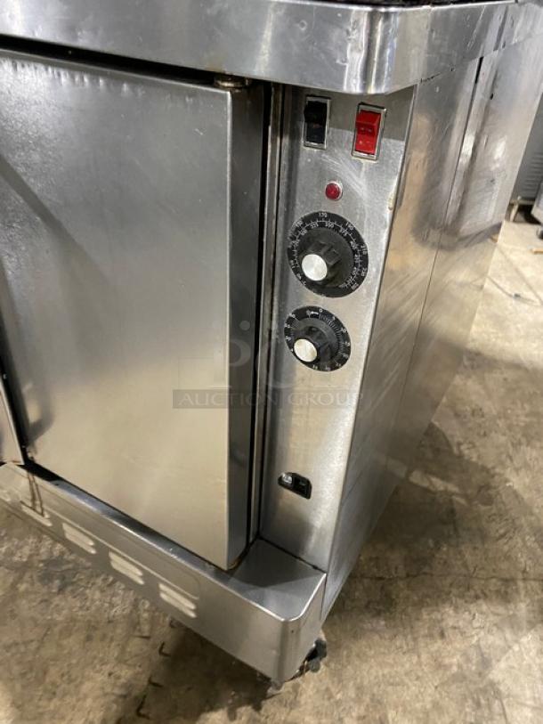 Blodgett commercial stainless steel gas convection oven, double-stacked, with thermostatic controls and wired rack, on casters.