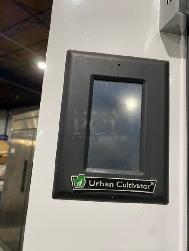 Urban Cultivator Commercial indoor garden, model Commercial001. White, double glass doors, 120V, electric-powered, on casters.