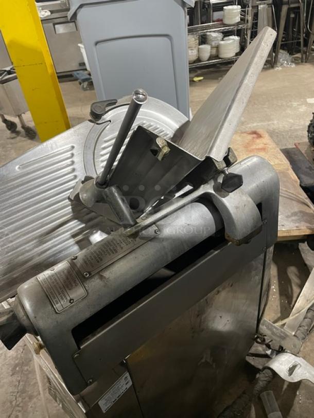 Hobart 1612E commercial electric deli meat slicer, stainless steel, 115V, visible condition labels, used countertop model.