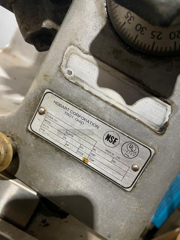 Hobart Model 1612E deli meat slicer, electric-powered, 115V, with visible serial number and NSF certification label.